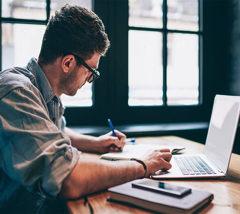 Professional developing brand messaging, communication frameworks and content strategy on a laptop.