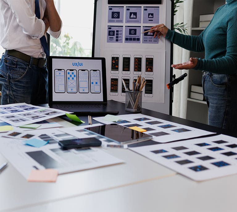 Website wireframes displayed across mobile and tablet devices during a user-focused web design planning session.