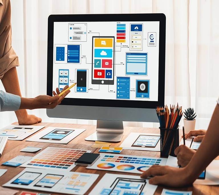 Website interface layouts, wireframes and visual design elements being reviewed during a web design project.